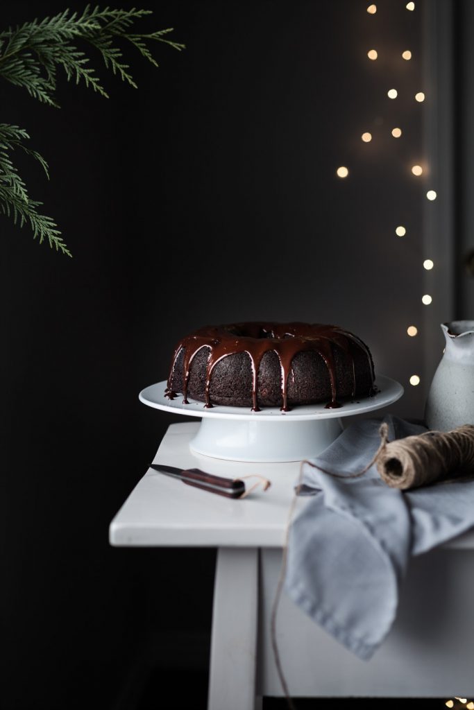 head on image of vegan chocolate bundt cake with chocolate ganache.