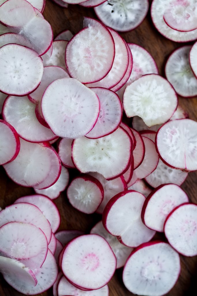 overhead close up on slices french breakfast radishes.