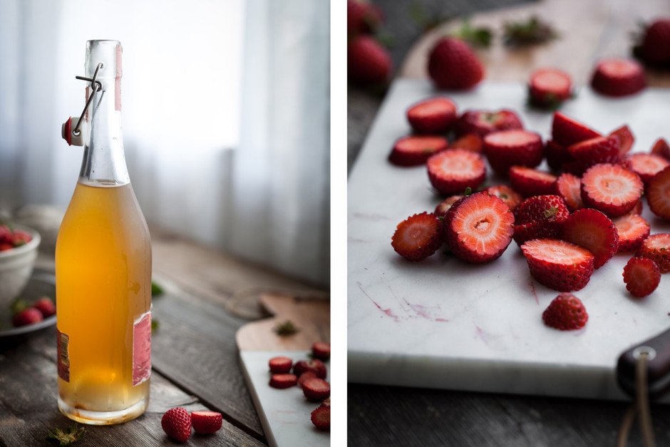 LEFT: a bottle of kombucha next to strawberries. RIGHT: slices strawberries on a cutting board.