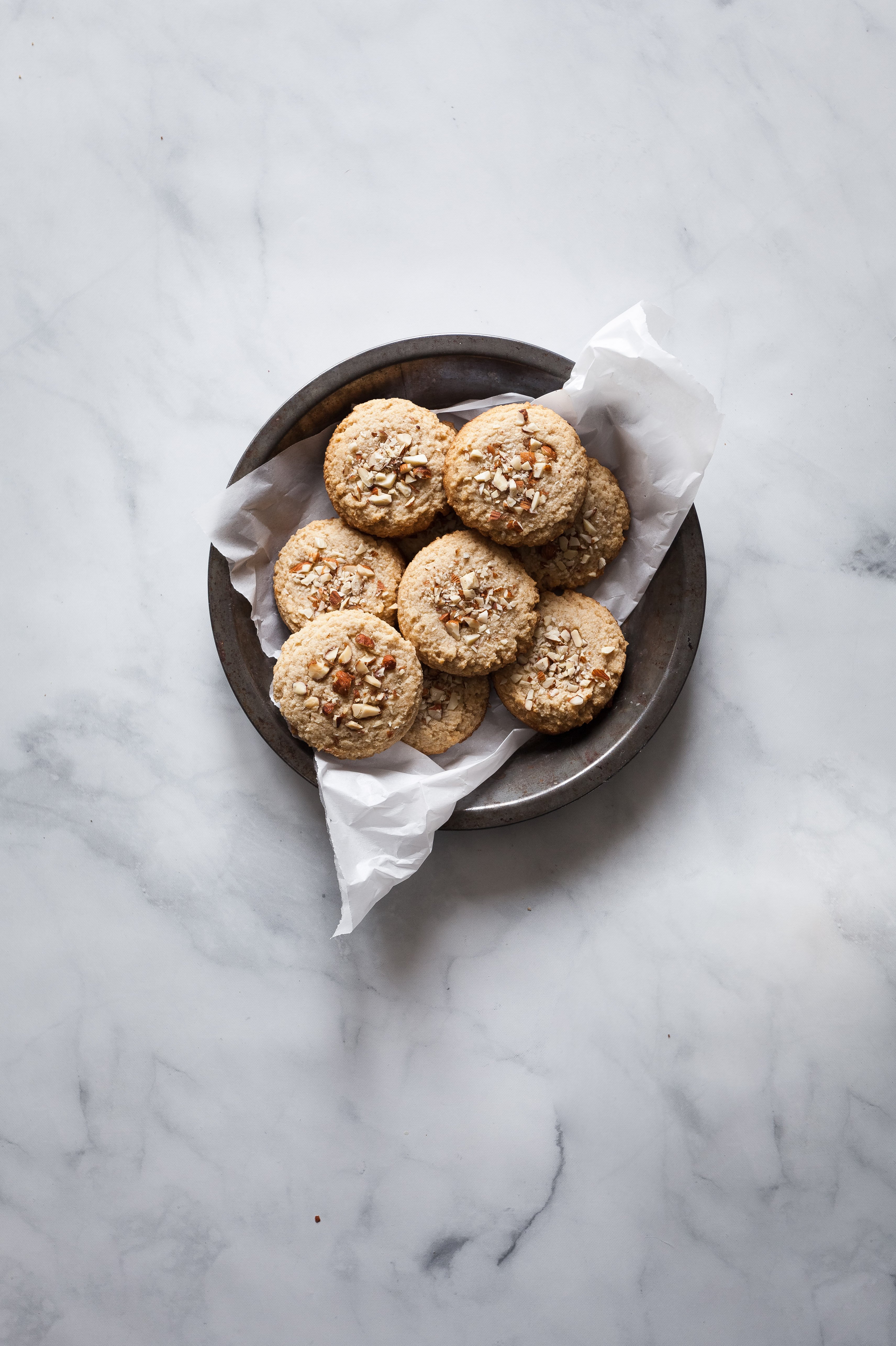 overhead image of cookies in a pie plate with parchment paper.