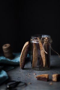 a head on image of Biscotti cookies in a glass jar.