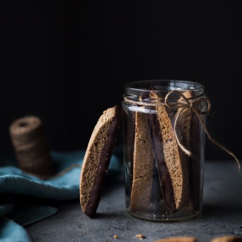a head on image of Biscotti cookies in a glass jar.