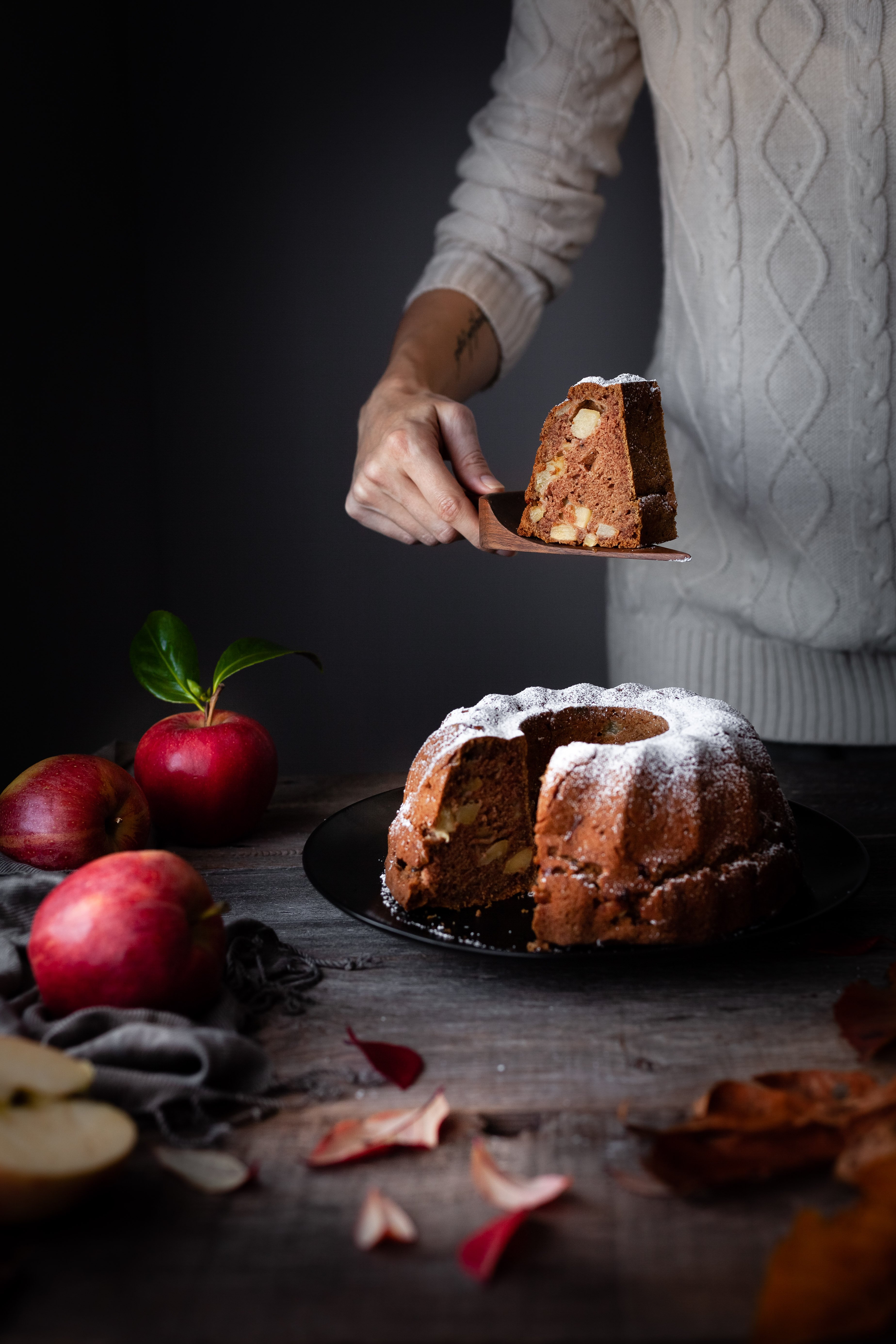 head on image of vegan apple spice cake with slice removed.