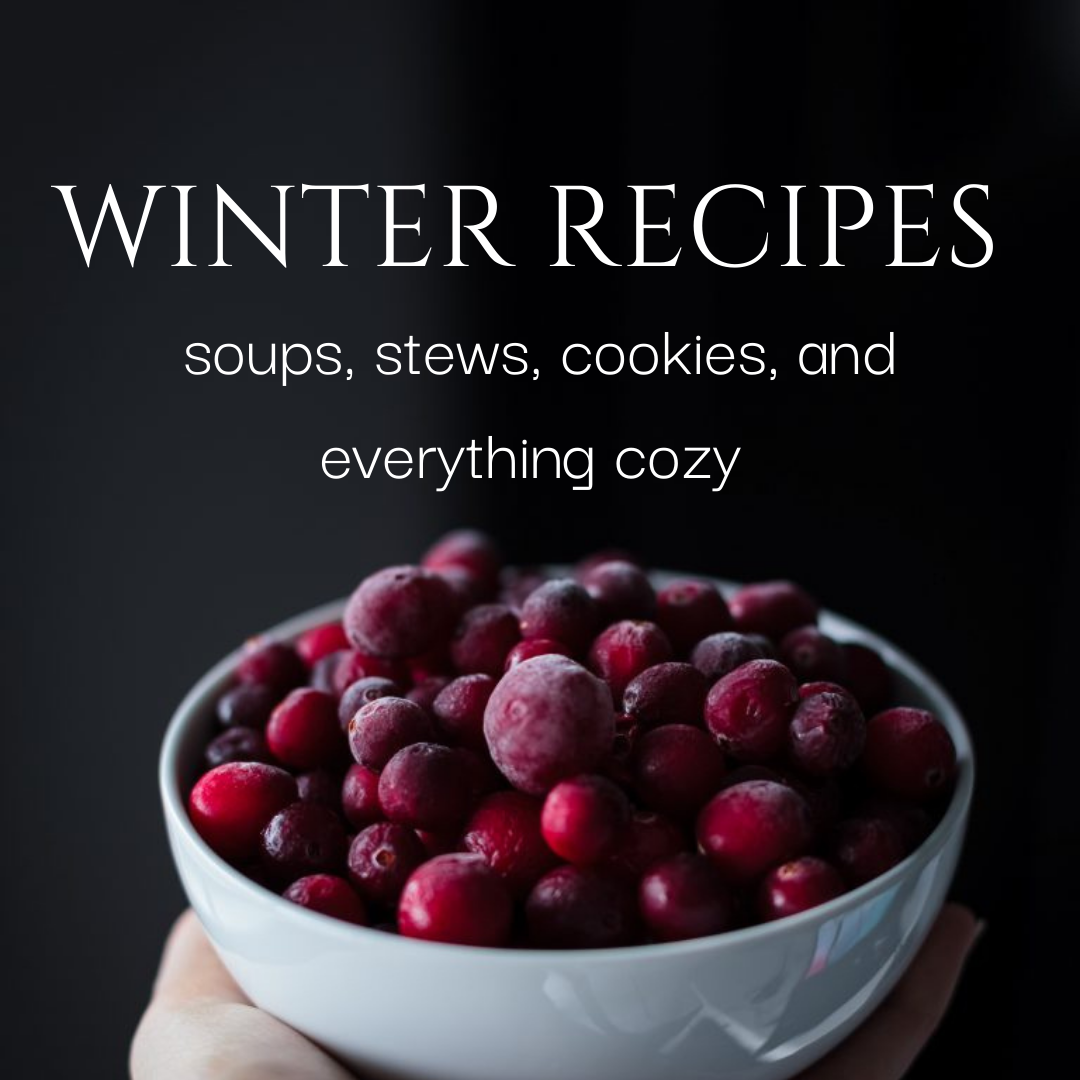 a hand holding a bowl of frozen cranberries.