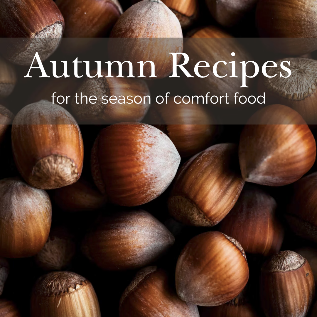 Hazelnuts in their shell with text overlay "Autumn recipes for the season of comfort food".