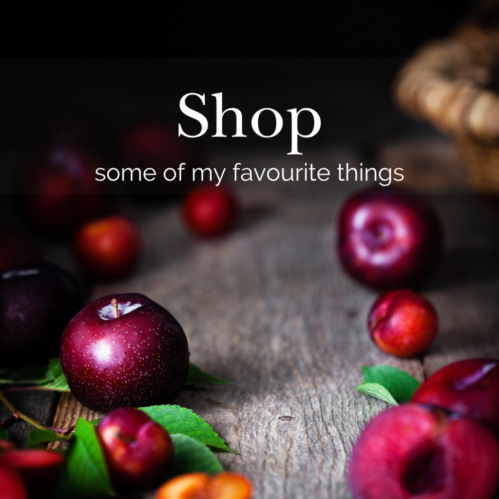 plums on a wood surface with text overlay "shop some of my favourite things".